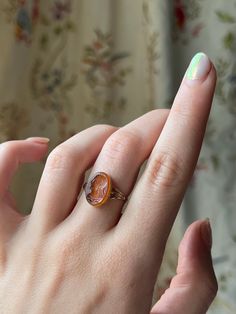 Once in a while we meet a special ring that we just can't put down. This rare grand tour intaglio is one such jewel-- with a beautiful Persian carving that is likely a 19th century revival of an ancient rendering on this theme, the stone seems to glow within. Set with a Victorian style shank, it is becoming increasingly harder to find beautiful carnelian intaglios of this caliber; note that the figure is wearing a long, sumptuous drop earring and a scalloped collar. This would be a memorable add Antique Carnelian Intaglio Rings, Vintage Oval Carved Engraved Ring, Vintage Carnelian Hallmarked Ring, Victorian Oval Carved Rings, Vintage Carnelian Signet Ring For Formal Occasions, Vintage Carnelian Signet Ring, Vintage Carnelian Yellow Gold Ring, Formal Carnelian Cameo Jewelry, Vintage Yellow Gold Carnelian Ring