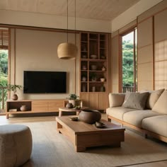 a living room filled with furniture and a flat screen tv mounted on a wall above a wooden coffee table