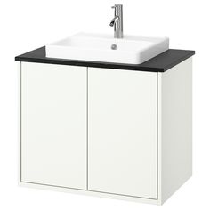 a white sink sitting under a faucet next to a cabinet