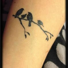 two birds sitting on a tree branch tattoo