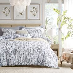 a bed with blue and white comforters in a bedroom