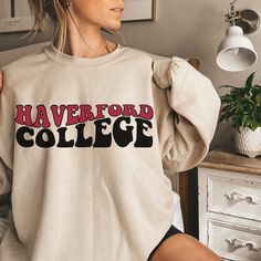 Title: Personalized Haverford College Sweatshirt - Customizable Unisex Design Description: Welcome to our vibrant collection of Haverford College Sweatshirts, where school pride meets exceptional style! Designed to capture the hearts of new college students, proud parents, graduating seniors, and college sports fans alike, this sweatshirt is a must-have addition to your wardrobe. Our Haverford College Sweatshirt is crafted with care, using the renowned Gildan 18000 model. Available in classic co College Spirit Wear, New College Student, Tailgate Essentials, University Apparel, Pride Wear, Sports Lover Gifts, College Gear, Campus Style, College Apparel