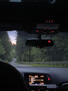 the dashboard of a car with trees in the background