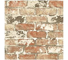 an old brick wall with white and brown paint