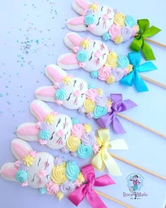 several colorful cake toppers with bunny ears and flowers on them