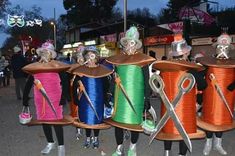 there are many spools of thread and scissors in this group on the street