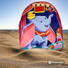 This Loungefly Mini Backpack Is Perfect For Disney Lovers! Featuring Dumbo And Timothy Characters. This Backpack Has A Red Exterior Color And Multicolor Lining. The Backpack Has A Zip Closure And A Top Handle For Easy Carrying. Playful Backpack For Theme Park, Fun Red Backpack Bag, Themed Red Travel Backpack, Red Themed Standard Backpack, Red Themed Backpack Bag, Themed Travel Backpack Bags, Themed Red Travel Bag, Red Disney Travel Bag, Disney Red Travel Bag