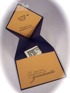 an orange and blue folded graduation card