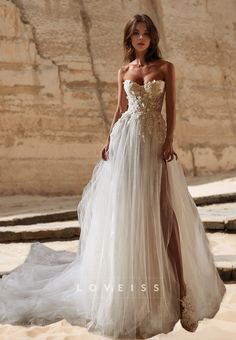 a woman in a wedding dress standing on the beach