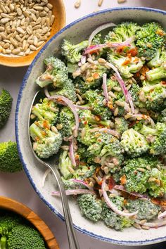 a bowl filled with broccoli, onions and sunflower seeds