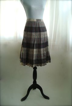 "This is a classic wool plaid, pleated secretary, or career skirt. This high waisted skirt features a back zipper and button closure and a lovely plaid in shades of grey with red. This skirt is in excellent condition. Skirt is a size medium, please see measurements below.  14\" across waist, seam to seam hips free 25\" length, waist to hem" Classic Pleated Plaid Skirt, Plaid Full Skirt For Work, Elegant Fitted Plaid Skirt, Classic Plaid Skirt For Fall, Fitted Pleated Plaid Skirt, Retro Pleated Lined Skirt For Work, Scottish Style Fitted Pleated Skirt For Fall, Plaid Pleated Skirt For Workwear In Fall, Fall Scottish Pleated Skirt