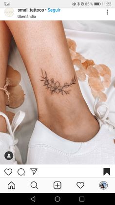 a woman's foot with a flower tattoo on the left side of her leg