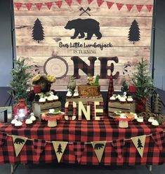 a table topped with lots of food and desserts next to a sign that says one