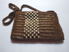 "A nice, very usable glass-beaded purse with a secure zipper closure and a strap to wear over the shoulder. Size approx: 7.75\" wide by 5.25\" tall, 13\" handle drop Colors: gold, bronze-brown Tag: Walberg, Made in Hong Kong Weighs: 8 oz. Condition: VERY GOOD. No bead loss or wear. Clean inside. Thanks for looking! International buyers, please contact me regarding shipping costs. And please do visit my store home page: https://www.etsy.com/shop/LionandLambVintage" Beaded Brown Shoulder Bag Gift, Brown Beaded Pouch Bag, Brown Beaded Handheld Bag, Handheld Brown Beaded Bag, Handmade Brown Rectangular Evening Bag, Brown Beaded Pouch Shoulder Bag, Evening Brown Beaded Shoulder Bag, Leather Biker Vest, Lion And Lamb