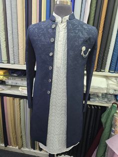 Introducing the epitome of elegance and sophistication, our exquisite Navy Blue Embroidered Sherwani. Crafted with meticulous attention to detail, this sherwani is a true masterpiece that will make you stand out on any special occasion. The navy blue fabric is adorned with intricate floral embroidery, creating a stunning visual appeal. The embroidery is meticulously hand-stitched, showcasing the artistry of our skilled craftsmen. The sherwani features a classic mandarin collar, adding a touch of modern refinement.  The sherwani is designed to provide a comfortable and flattering fit. It is tailored to perfection, ensuring a sharp and elegant silhouette. The soft and breathable fabric allows for maximum comfort throughout the day or night.  Our navy blue embroidered sherwani is a timeless p Designer Embroidered Dupatta For Reception, Silver Kurta With Zari Work For Wedding, Silver Traditional Wear With Chikankari Embroidery For Weddings, Silver Wedding Kurta With Zari Work, Silver Transitional Wedding Traditional Wear, Silver Sherwani For Eid Wedding, Silver Sherwani For Wedding And Eid, Elegant Embroidered Fabric For Formal Occasions, Formal Silver Sets With Intricate Embroidery