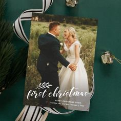 a christmas card with an image of a bride and groom on it next to ribbon