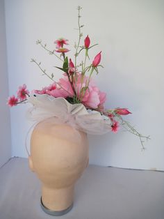 "* This pleated polka dot hat base has a 8\" diameter featuring an open pink silk peony, open roses, closed tulips and summer greens. * White millinery netting hides the underside of the hat base form and adds just a touch of texture variety and drama to the piece. * On a metal headband with a satin ribbon covering it is secure, well balanced and comfortable to wear for extended periods of time. * Upon ordering you will receive this exact headpiece. * Perfect for the Kentucky Derby or any other Spring Flower Hats For Races, Spring Races Flower Hat, Handmade Flower Mini Hats For Spring Races, Spring Mini Hats With Handmade Flowers For Races, Spring Mini Hat With Handmade Flowers For Races, Spring Flower-shaped Fitted Fascinator, Spring Adjustable Fascinator With Handmade Flowers, Spring Fascinator With Handmade Flowers, Spring Flower Fascinator For Races