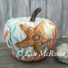 a painted pumpkin with a starfish on it