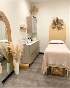 a spa room with two beds, mirrors and towels on the counter top next to each other