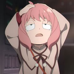 an anime character with pink hair and green eyes is holding her head in the air