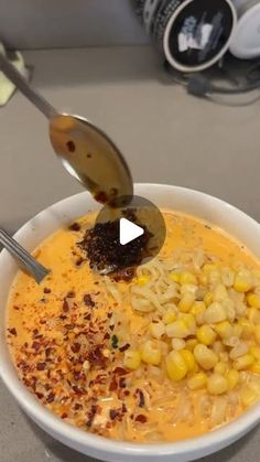 a bowl filled with soup and corn on the cob