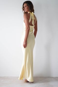 Highlights Stunning halterneck maxi dress Gorgeous open-back detail Thick satin material Available in Blue, Oyster, Yellow, Butter Yellow & Pink Sizing The model is 5'10 and wears UK size 8 / S / US size 4 Fit & Fabric Made from 98% Polyester & 2% Spandex True to size Adjustable drawstrings Double lined Length from top of neck to hem: 155cm Stretch: 5/10 Perfect for Bridesmaids Graduations Wedding Guests Prom Dresses Classy, Oh Hello Clothing, Holiday Fits, Yellow Bridesmaid, Classy Prom, White Bridal Dresses, Maxi Dress Wedding Guest, Yellow Maxi Dress, Yellow Bridesmaid Dresses