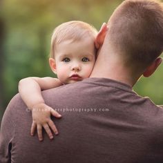 a man holding a baby in his arms