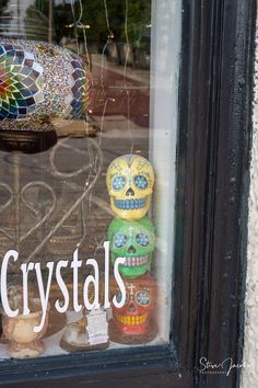 there is a glass window that has skulls in it and the words crystalls on it