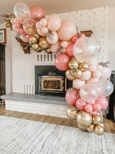 a bunch of balloons that are in front of a fireplace