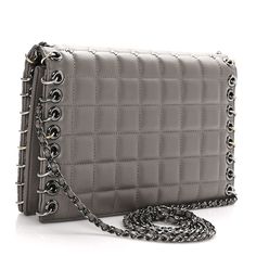 This is an authentic CHANEL Lambskin Chocolate Bar Piercing CC Studded Small Chain Flap Bag in Grey. This stylish bag is crafted of luxurious lambskin leather embellished with small CC logos in a quilted pattern. The bag features an embellishment of rings and grommets, and a chain link leather threaded shoulder strap. The flap opens to a satin interior with a flat pocket. Piercing Cc, Chanel Chain Bag, Bar Piercing, Chanel Crossbody, Quilting Frames, Quilted Wallet, Denim Quilt, Quilted Pattern, Leather Thread