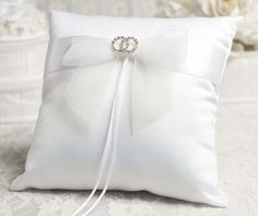 a white pillow with a bow on it