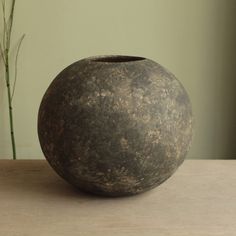 a vase sitting on top of a wooden table