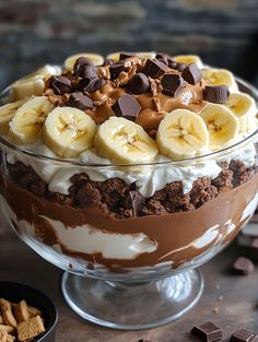 a dessert dish with chocolate, bananas and graham crackers in it on a table