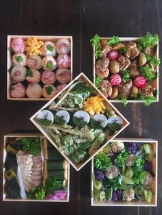 four small trays filled with different types of food on top of a wooden table