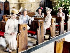 four women sitting in pews at a church