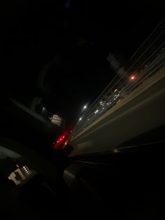 the back end of a car driving down a highway at night