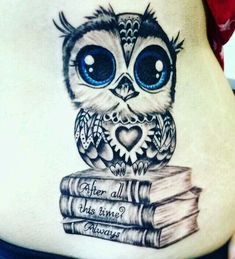 an owl is sitting on top of some books