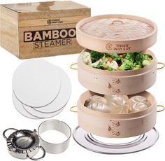 bamboo steamer set with three trays and 3 rings for serving food, including broccoli