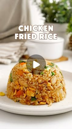 chicken fried rice on a white plate with the words chicken fried rice in front of it