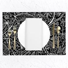 a black and white place setting with silverware