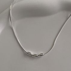 Add an elegant touch to your outfit with this beautiful Triple Charm Necklace. This necklace features three small beads on a gorgeous box snake chain. Wear it on a night out or to a wedding. It's dainty, simple, and versatile. Material: 925 Sterling Silver Closure: Spring Ring Clasp with an Extended Chain Chain Type: Snake Box Chain Chain Length: Approx. 16.0" + 2.0" Comes in a gift box with a microfiber bag. All of our jewelry is hypoallergenic. For more details on material and care, click here Elegant Silver Snake Chain Necklace With Adjustable Chain, Elegant White Gold Snake Chain Necklace Gift, Elegant White Gold Sterling Silver Snake Chain Necklace, Minimalist Snake Chain Necklace For Formal Occasions, Elegant White Gold Snake Chain Necklace, Elegant Sterling Silver Snake Chain Necklace With Adjustable Chain, Elegant Sterling Silver Snake Chain Necklace, Elegant Silver Snake Chain Necklace For Gift, Minimalist White Gold Snake Chain Necklace