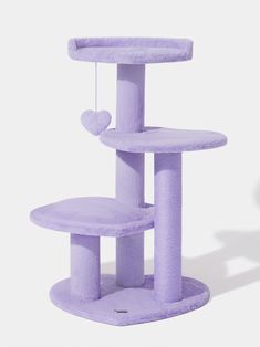 a purple cat tree with hearts hanging from it