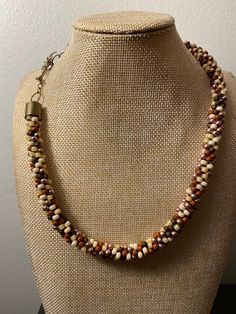 This size 6 seed bead, kumihumo necklace is the perfect piece of jewelry to add to your fall wardrobe. The glass beads are a mix of dark brown, medium brown, cream, a shimmery off white, and gold so they work with almost any outfit and are perfect for work or a night on the town. This elegant necklace is finished with an antique gold-colored toggle clasp that features a flower. There is a matching bracelet as well. Syracuse Ny, Matching Bracelet, Elegant Necklace, Elegant Necklaces, Matching Bracelets, Cream And Gold, Medium Brown, Toggle Clasp, Fall Wardrobe