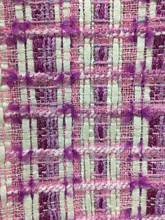 a close up view of a purple and white woven material