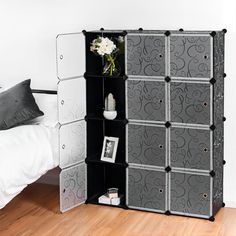 a black and white storage unit in a bedroom