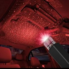 the interior of a car with red lights on it and a flashlight in the front seat