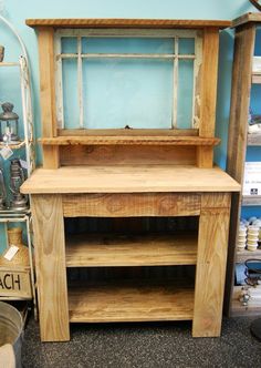 an old wooden cabinet with glass doors on the top and bottom, in a store