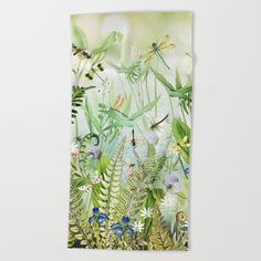 a towel with dragonflies and flowers in the background on a white wall hanging from a hook