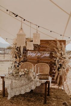 a table and chairs are set up under a tent