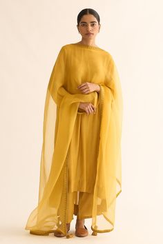 Bright mustard cotton silk kurta with round neck, high-low hem, back gathered panel, floral vine pattern resham and zari embroidered details. Paired with straight fit pants and organza dupatta with floral vine pattern zari hand embroidered border.
Components: 3
Pattern: Hand Embroidered
Type Of Work: Resham and Zari Work
Neckline: Round Neck
Sleeve Type: Three Quarter Sleeves
Fabric: Cotton Silk, Dupatta: Organza
Color: Yellow
Other Details: 
Side pockets
Side high slits on kurta
Tasselled edges Yellow Anarkali, Blouse Yoke, Vine Pattern, Straight Fit Pants, Silk Kurta, Embroidered Border, Zari Work, Organza Dupatta, Kurta With Pants